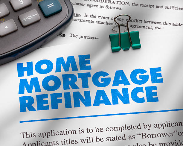 Home Mortgage Refinance Application and pen and calculator. ++All numbers and text are fictitious++