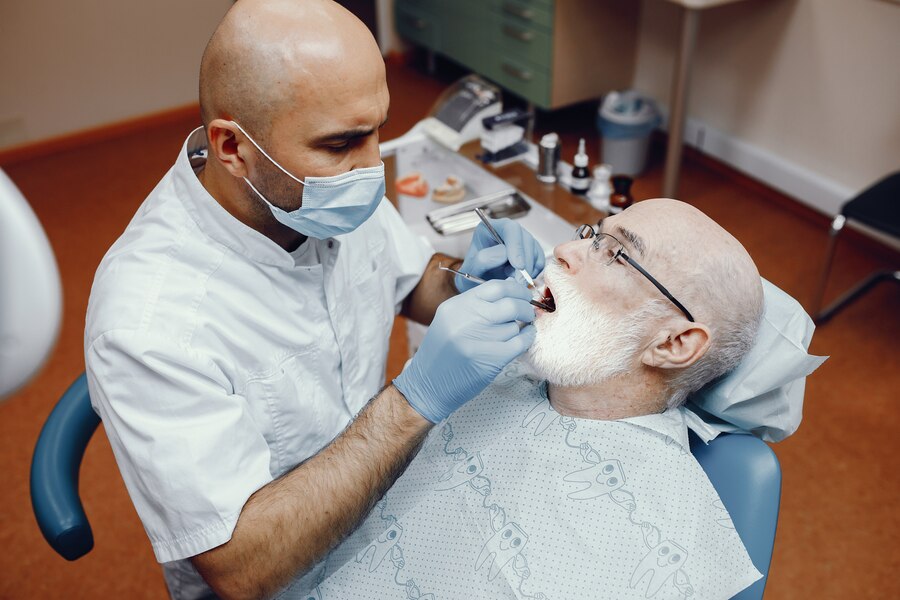 Old man sitting in the dentist's office